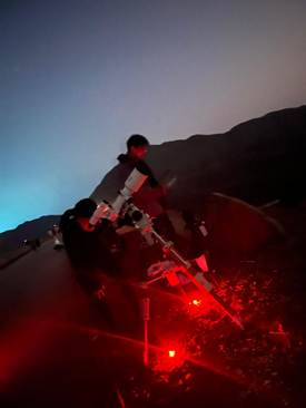 A person standing in front of a red light

AI-generated content may be incorrect.